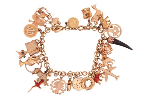 Lot 157 - A charm bracelet, composed of a fancy link...