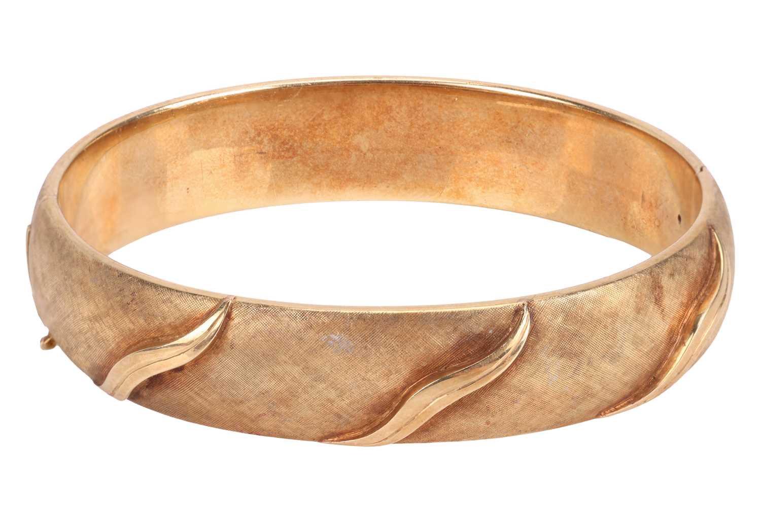 Lot 56 - A hinged bangle of oval form, with...