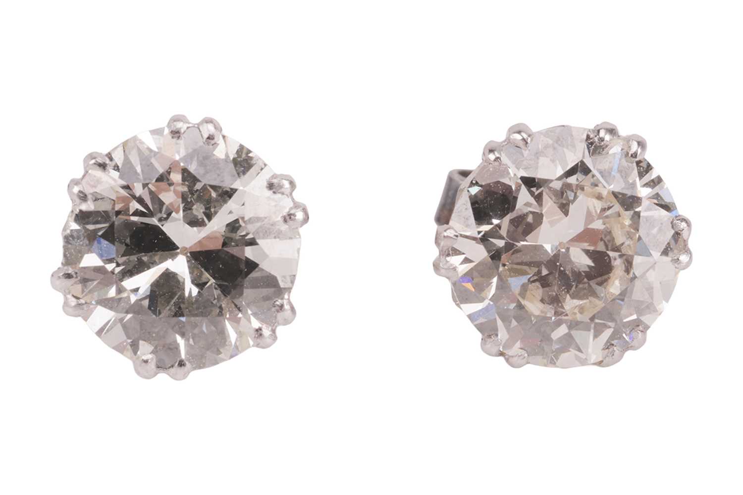Lot 60 - A pair of diamond stud earrings, each set with...