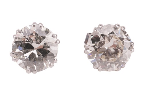 Lot 60 - A pair of diamond stud earrings, each set with...