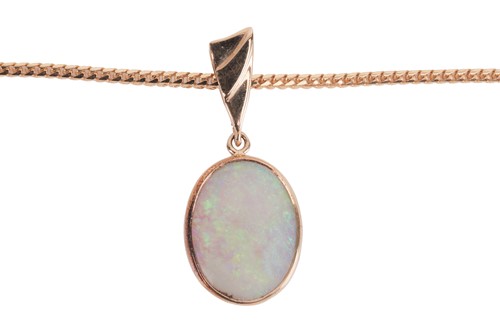 Lot 95 - An opal pendant on chain, featuring an oval...