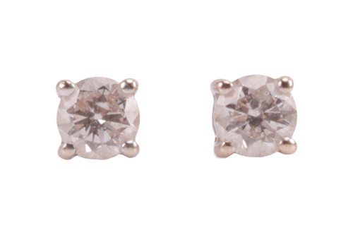 Lot 179 - A pair of diamond stud earrings, each claw-set...