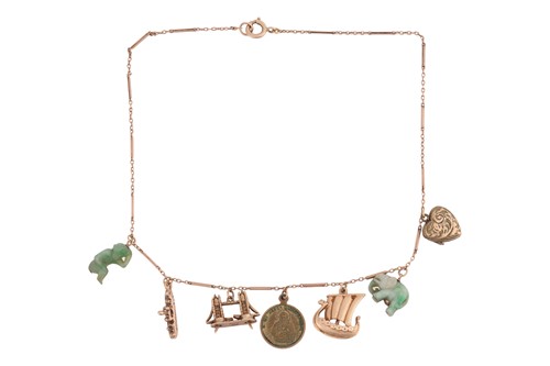 Lot 102 - A charm necklace, consisting of a fancy link...