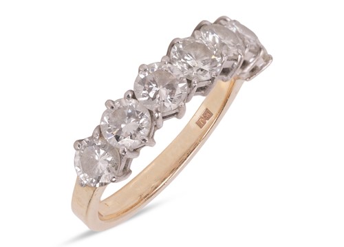 Lot 112 - A diamond seven stone half eternity ring,...