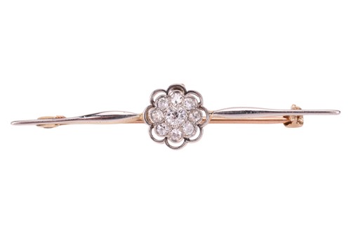 Lot 36 - A diamond-set bar brooch, featuring a central...