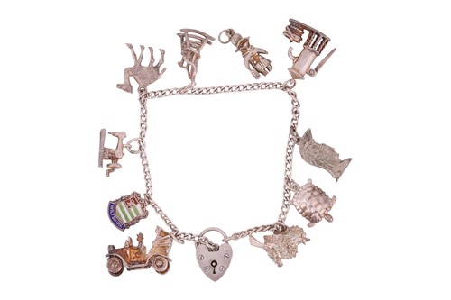 Lot 85 - A charm bracelet, comprising ten charms (one...