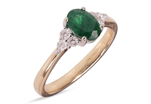 Lot 132 - An emerald and diamond dress ring in 18ct gold,...