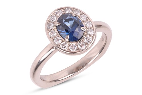 Lot A sapphire & diamond cluster ring, featuring a...