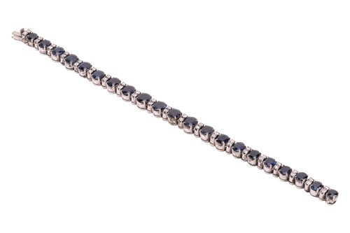 Lot 133 - A sapphire and diamond-set bracelet, featuring...