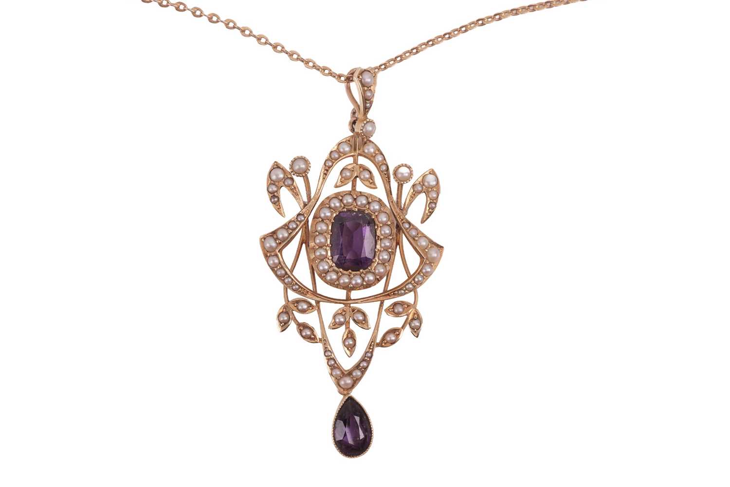 Lot 33 - An Edwardian amethyst and split pearl pendant...