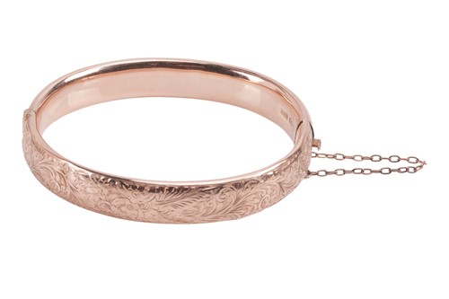Lot 66 - A hinged bangle in 9ct gold, constructed by...