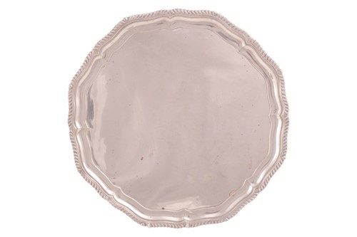 Lot 276 - An Edwardian silver scalloped circular tray...
