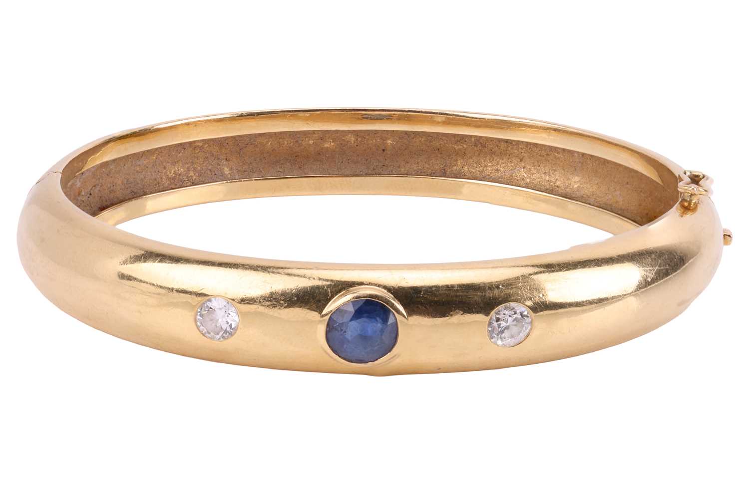 Lot 61 - A sapphire and diamond set hinged bangle, set...