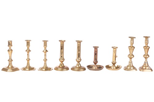 Lot A pair of early Georgian brass candlesticks,...