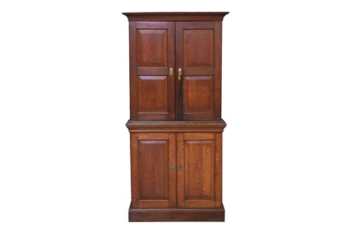 Lot 30 - A 19th-century tall oak cupboard, in two...
