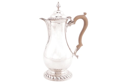 Lot 251 - A silver baluster hot water jug of George I...