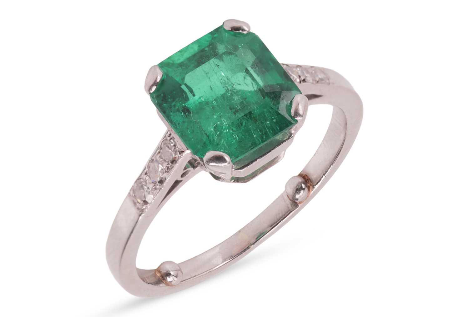 Lot 57 - A Colombian emerald dress ring, claw-set with...