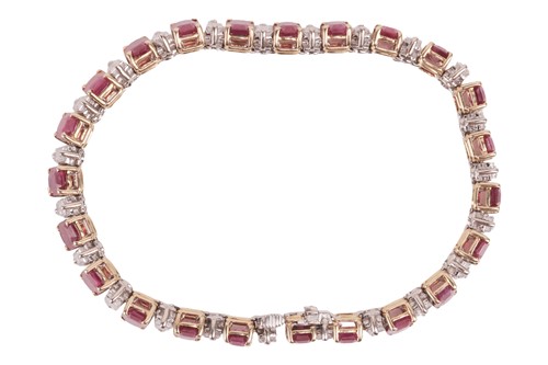 Lot 111 - A ruby and diamond line bracelet, set with...