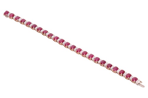 Lot 111 - A ruby and diamond line bracelet, set with...