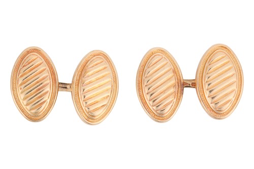 Lot 99 - A pair of oval cufflinks, with diagonal ribbed...
