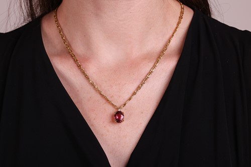 Lot 114 - A tourmaline and diamond pendant and chain,...