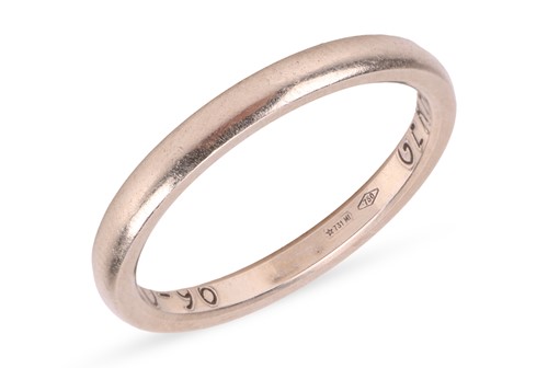 Lot 50 - A court-shaped plain band, stamped 750, ring...