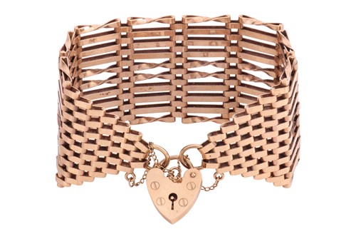 Lot 7 - A wide 9ct gold gate bracelet, with heart...