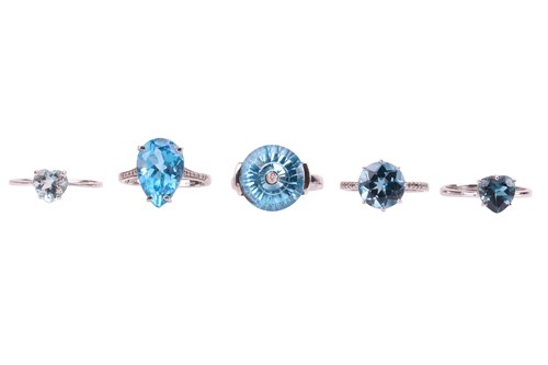 Lot 52 - Five blue topaz rings; two with diamond-set...