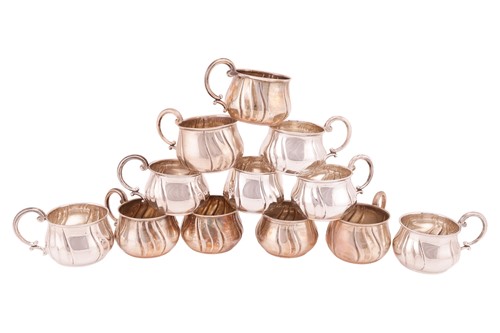 Lot 253 - A set of twelve cups, of squat lobed form with...