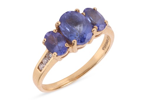 Lot 146 - A tanzanite and diamond ring, set with three...