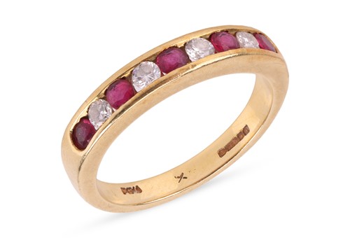Lot 115 - A ruby and diamond half eternity ring,...