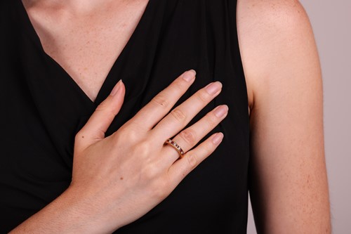 Lot 115 - A ruby and diamond half eternity ring,...