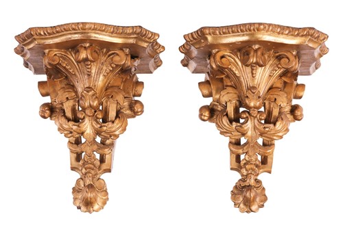 Lot 83 - A pair of carved giltwood wall sconces, of...