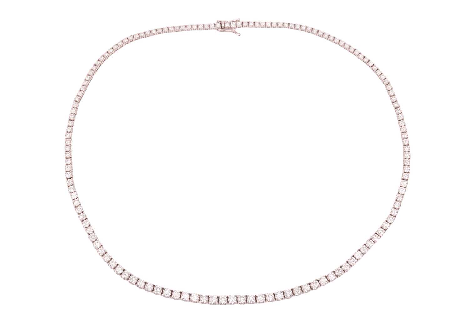 Lot 104 - A diamond riviere necklace, featuring one...