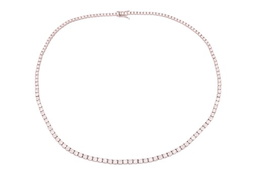 Lot 104 - A diamond riviere necklace, featuring one...