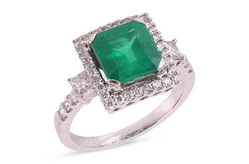 Lot 105 - An emerald and diamond ring, set with a square...