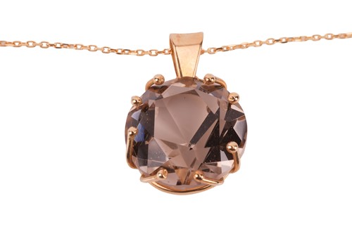 Lot 42 - A smoky quartz pendant on chain, claw-set with...