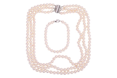 Lot 95 - A three-row cultured Akoya pearl necklace and...