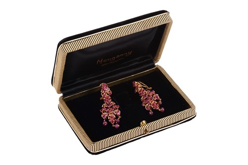 Lot 107 - A pair of ruby-set drop earrings of foliate...