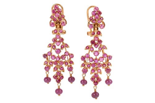 Lot 107 - A pair of ruby-set drop earrings of foliate...