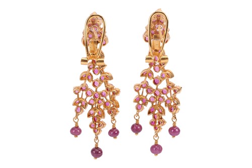 Lot 107 - A pair of ruby-set drop earrings of foliate...