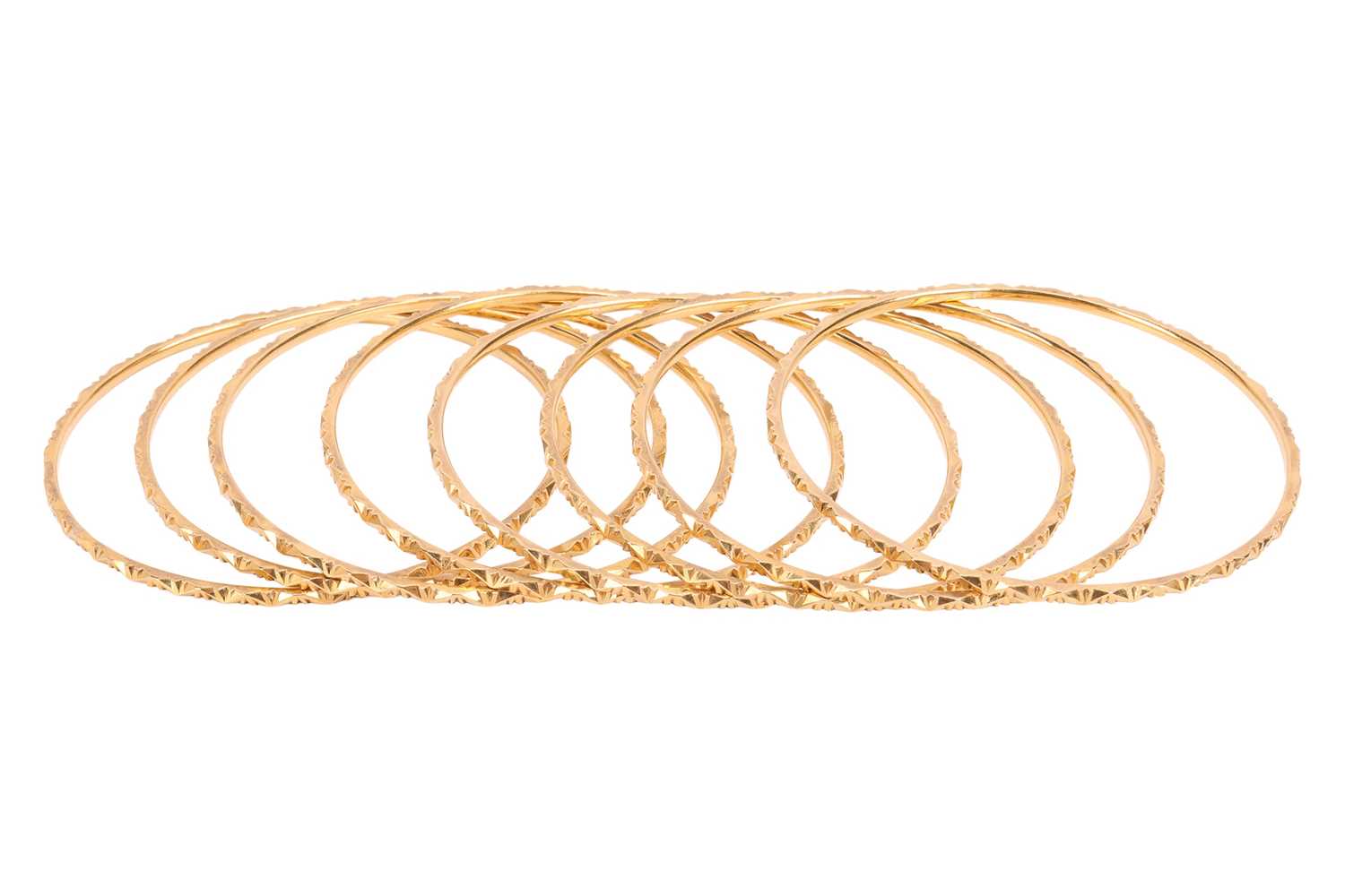 Lot 111 - A group of eight closed bangles, each...