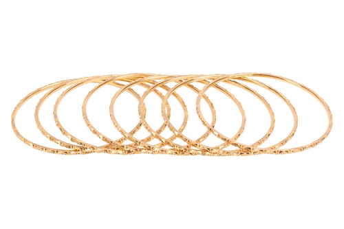 Lot 111 - A group of eight closed bangles, each...