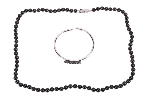 Lot 92 - A cultured black pearl necklace and bangle;...