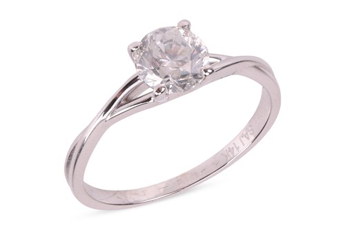 Lot A diamond solitiare ring, featuring a central...