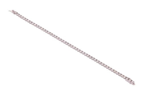 Lot A diamond line bracelet, comprising fifty-one...