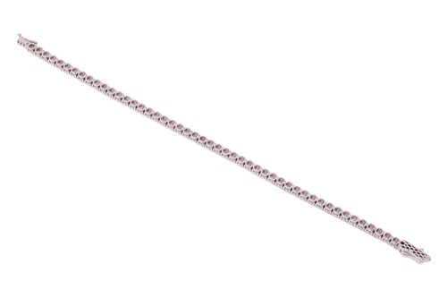Lot A diamond line bracelet, comprising fifty-one...
