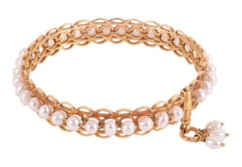 Lot 104 - A circular pearl-set bangle, of pierced design,...