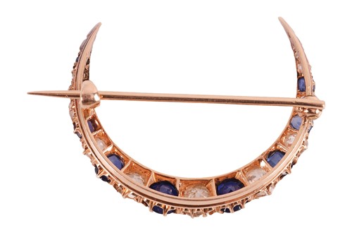 Lot A diamond and sapphire crescent brooch,...