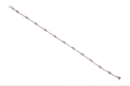 Lot 174 - A tanzanite and diamond tennis bracelet,...